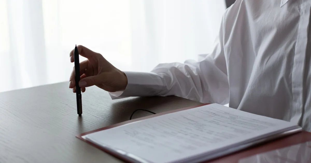 Indépendant comparant des offres de prévoyance sur son bureau avec des documents et un ordinateur